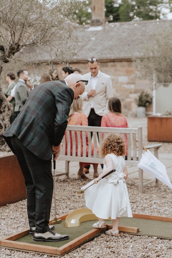 Guests play crazy golf at Dunglass Estate during wedding
