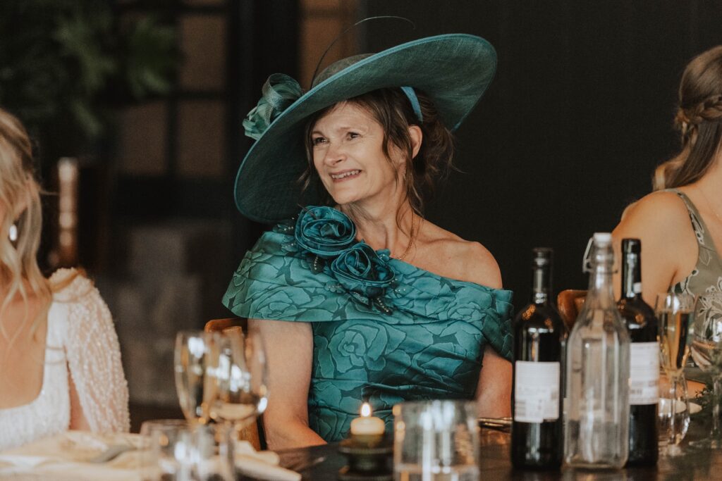 Mother of the bride laughing during speeches