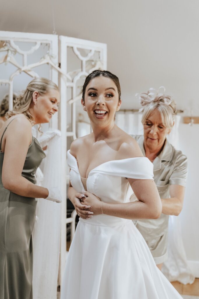 Bride Abbie getting ready in the cottage at Gaynes Park
