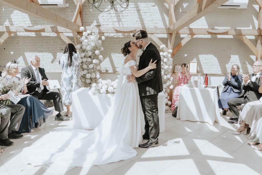 Classic white rose wedding flowers decorating the Orangery at Gaynes Park