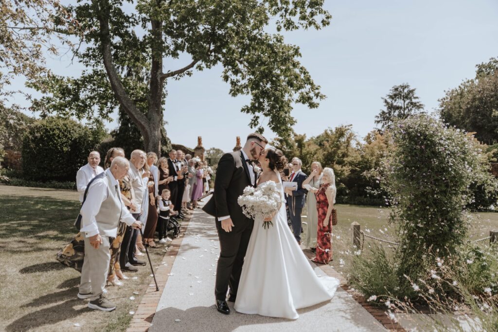 Confetti in the gardens at Gaynes Park during a wedding