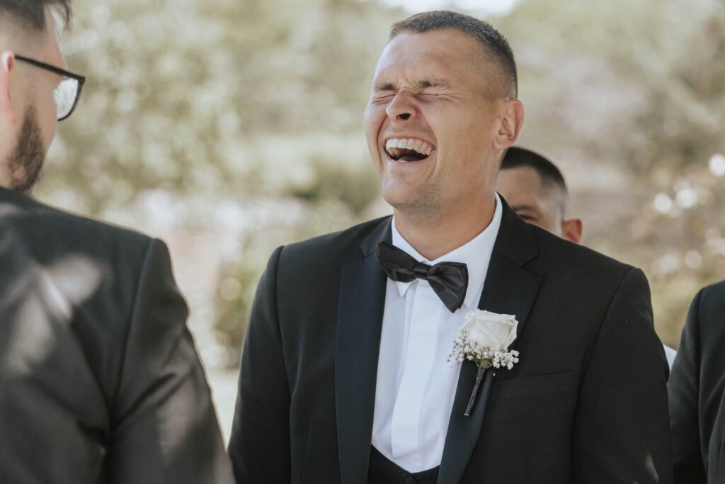 Guests chatting and enjoying the sunshine after an Essex wedding ceremony