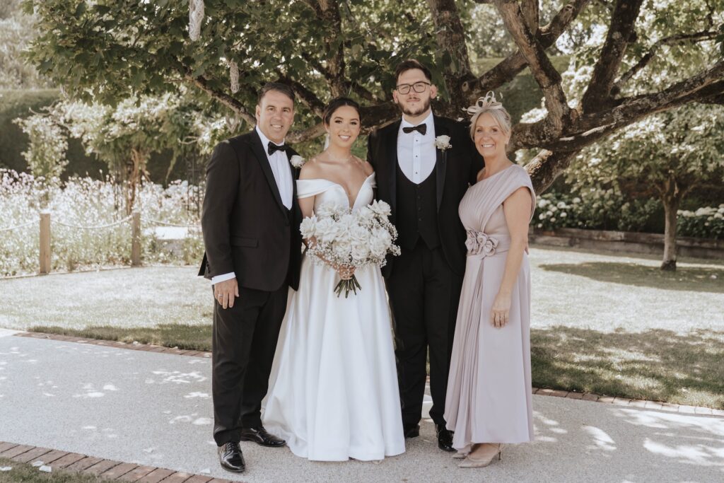 Abbie and Josh with their family beneath a tree at Gaynes Park