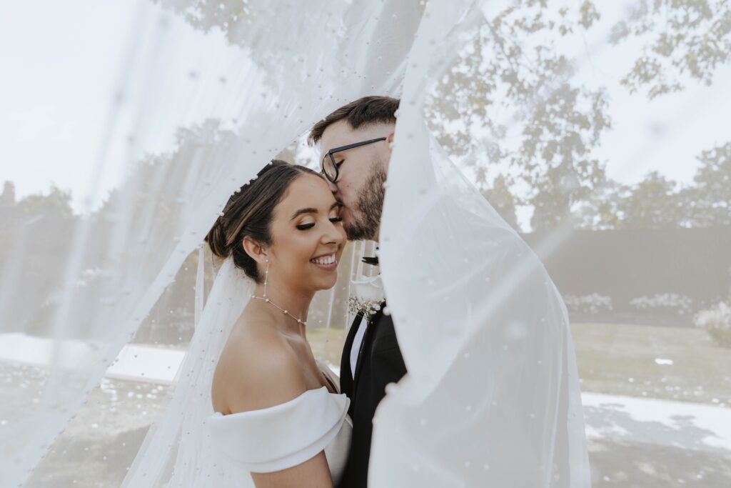 Abbie and Josh laughing together during their Gaynes Park wedding portraits