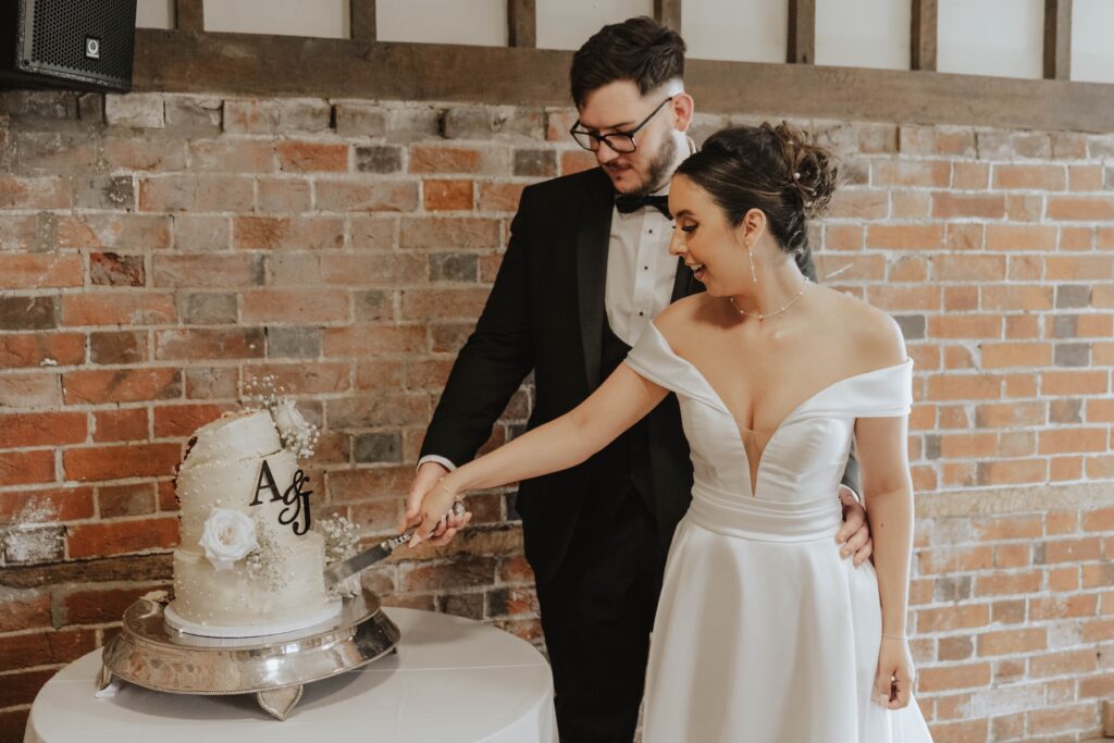 Funny wedding cake cutting moment at a Gaynes Park wedding