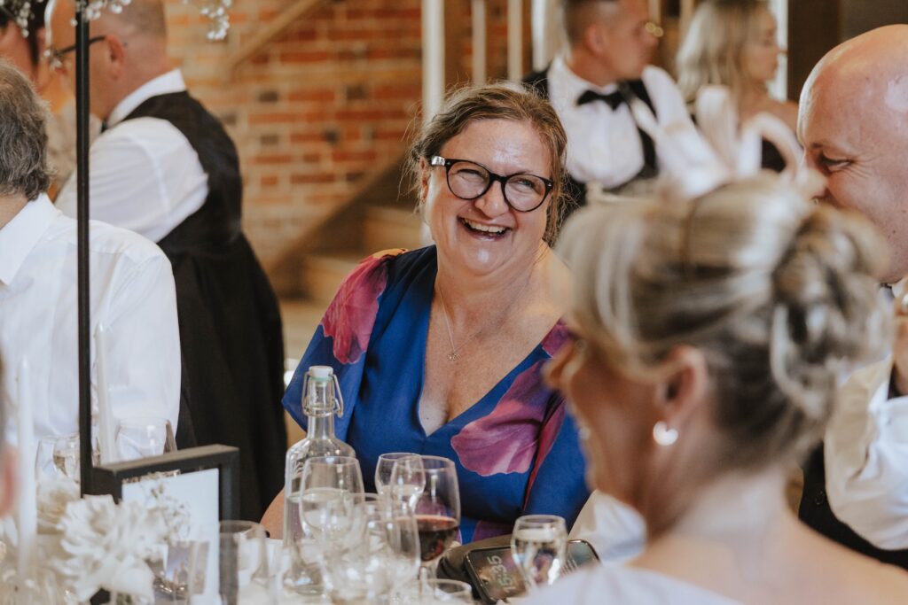 Wedding guests laughing during the speeches at Abbie and Josh's wedding