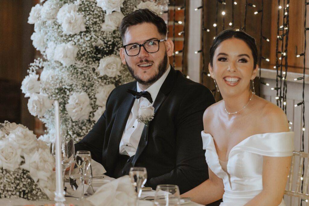 Bride and groom listening to speeches during their Essex wedding reception