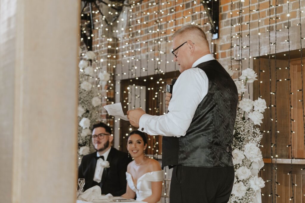 Guests listening to speeches during their Essex wedding reception