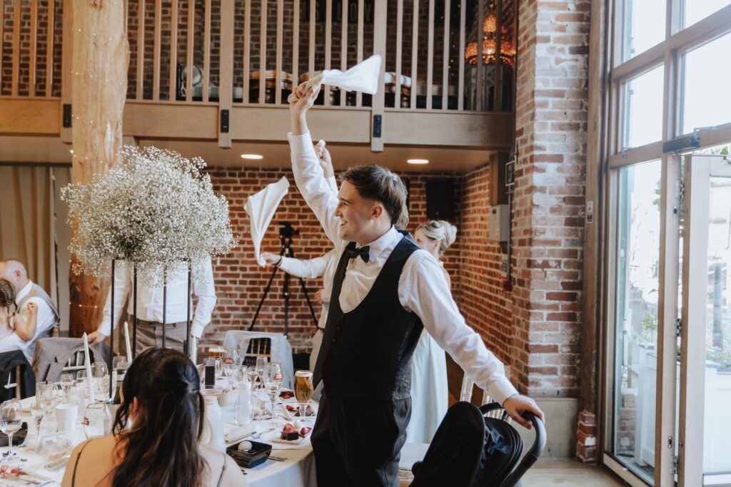 Surprise singing waiter performing during a wedding reception in Essex