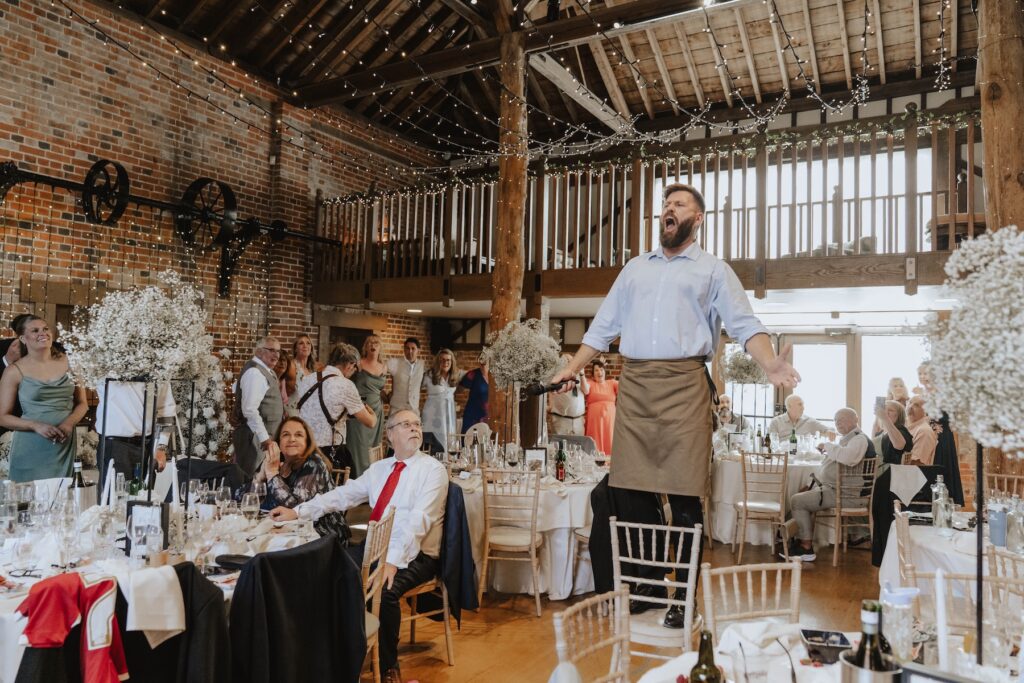 Guests enjoying a surprise entertainment performance at a Gaynes Park wedding