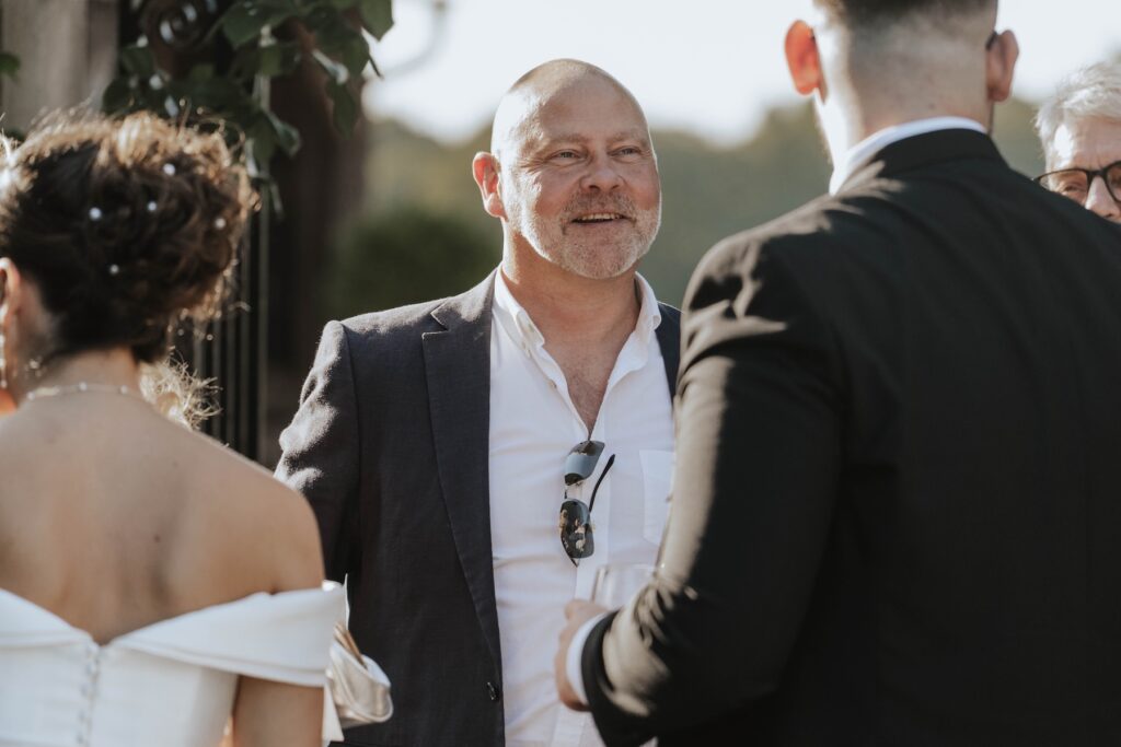 Candid photograph of guests enjoying cocktails at a Gaynes Park wedding