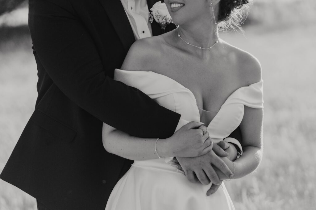 Newlyweds photographed beneath a golden evening sky at Gaynes Park