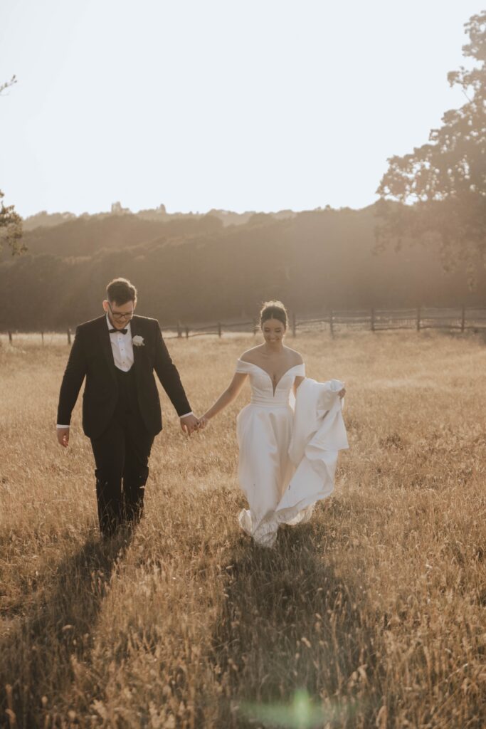 Abbie and Josh surrounded by golden summer fields on their wedding day