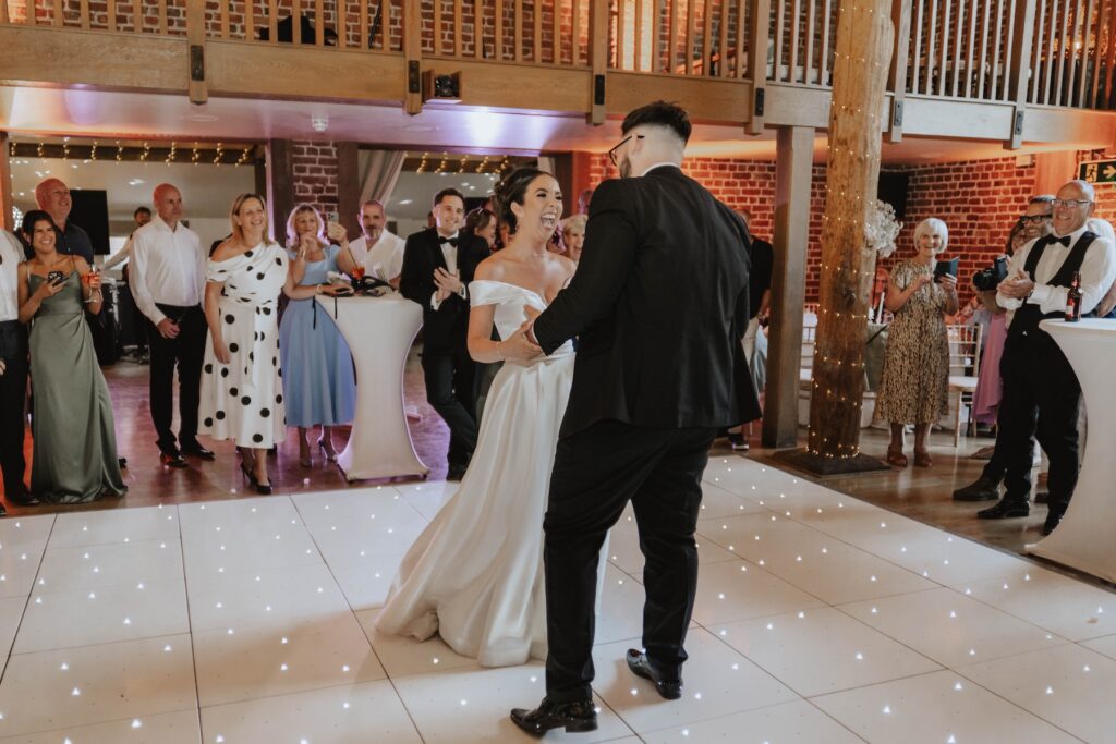 Bride and groom dancing together during their first dance in Essex