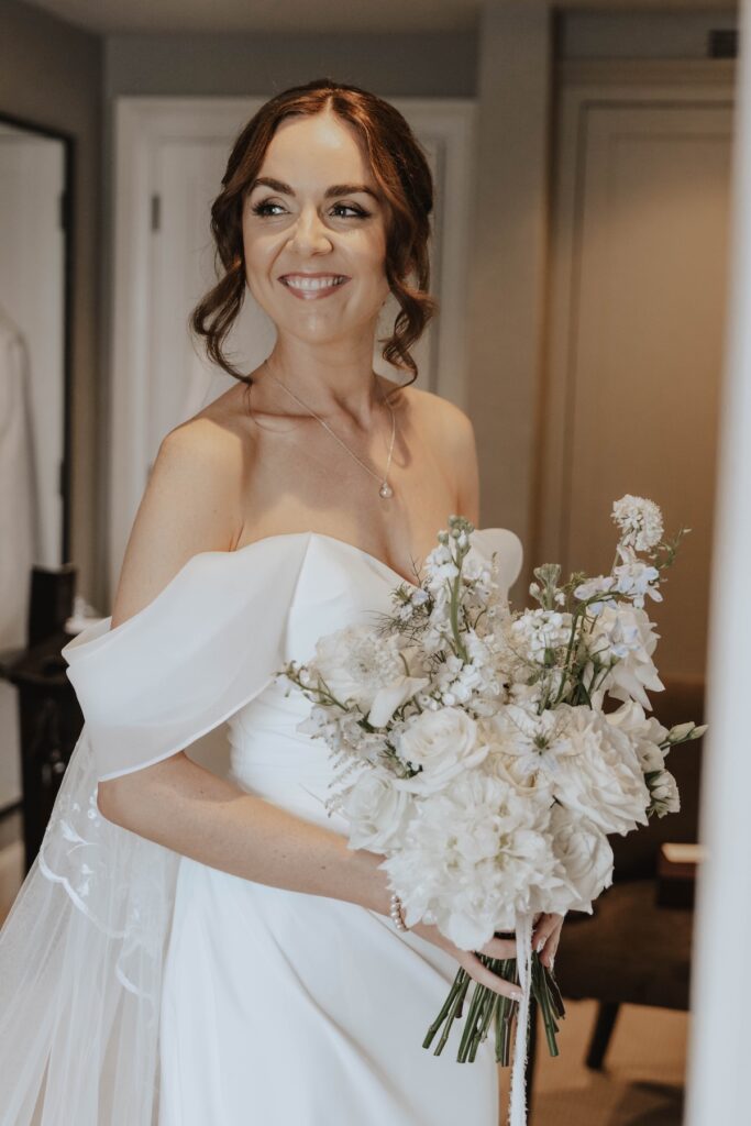 Bride wearing a wedding gown and cathedral-length veil at Marquis Suffolk