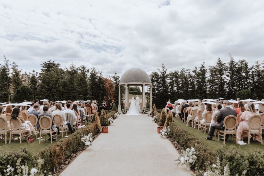 Lauren and James' outdoor wedding ceremony in the gardens at Marquis Suffolk