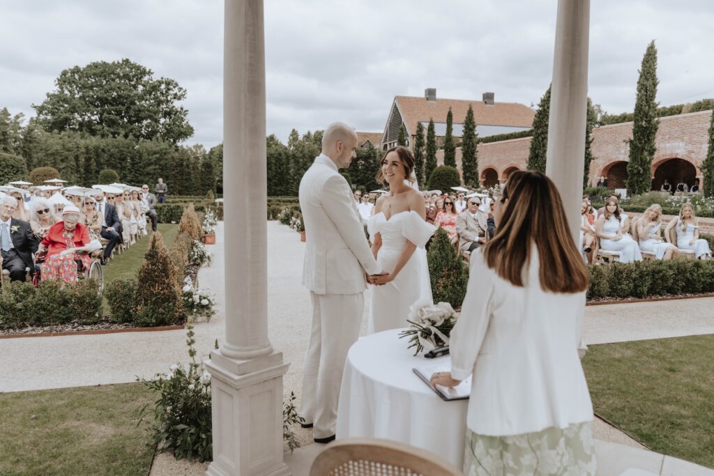 Candid wedding photograph during an outdoor ceremony at Marquis Suffolk