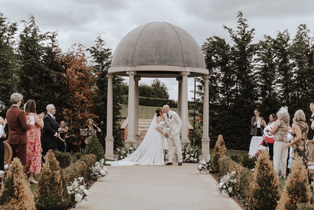 Newly married couple during their outdoor wedding ceremony in Suffolk
