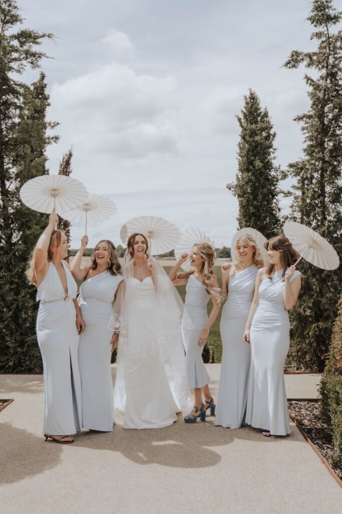 Lauren and James with their bridesmaids and family at Marquis Suffolk