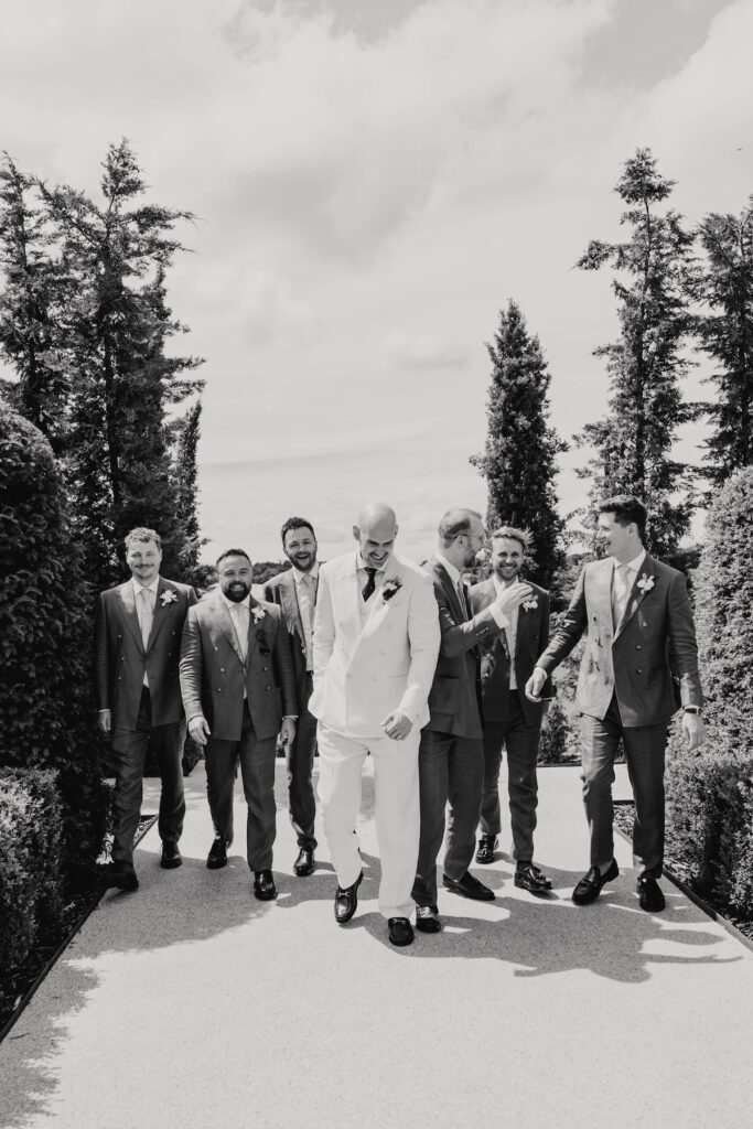 James and his groomsmen in light plum suits getting ready for a Suffolk wedding at Marquis