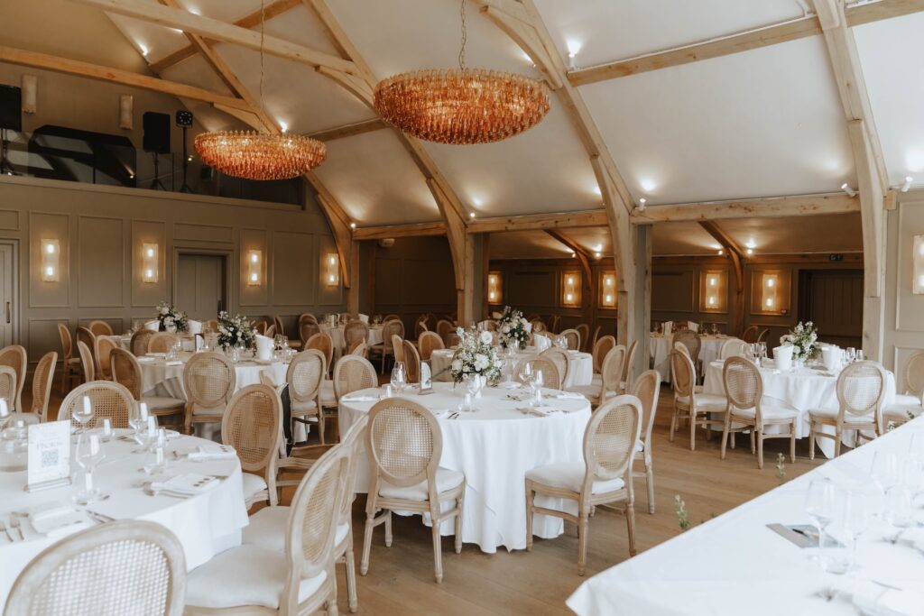 Wedding breakfast room decorated with creamy flowers at Marquis Suffolk