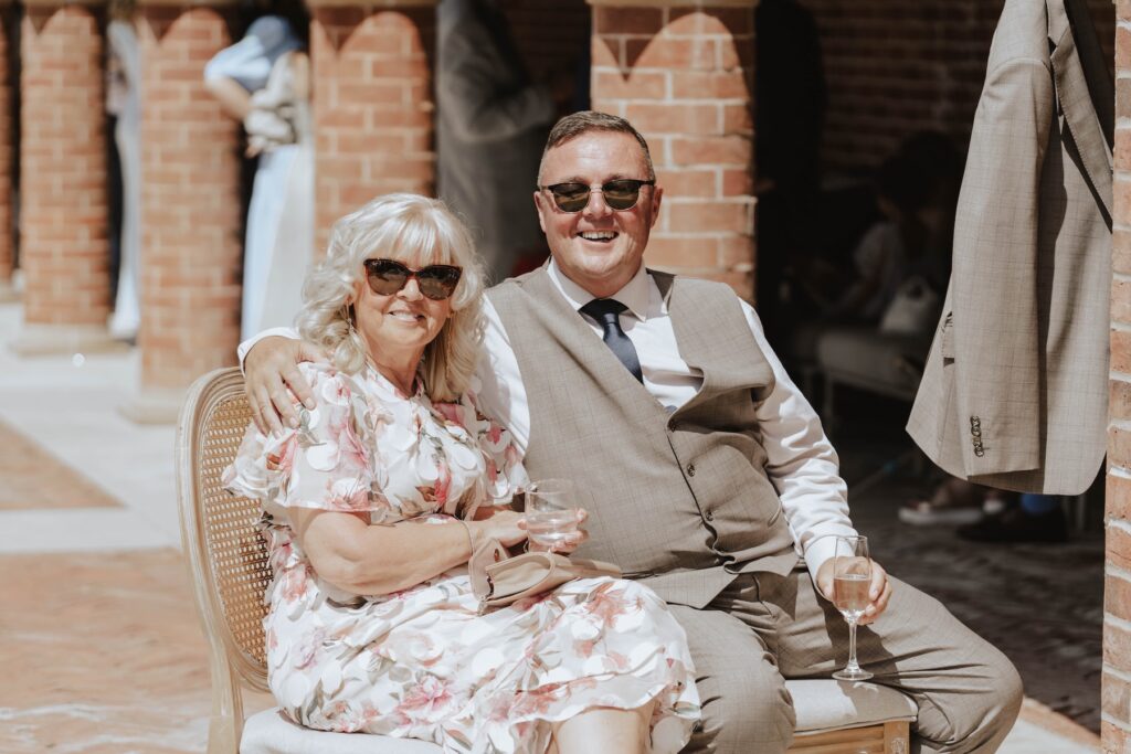 Guests chatting during an outdoor wedding reception in the gardens at Marquis Suffolk