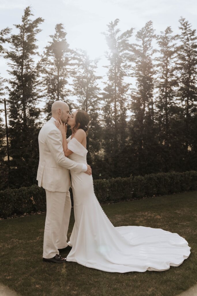 Bride and groom laughing together during their wedding portraits