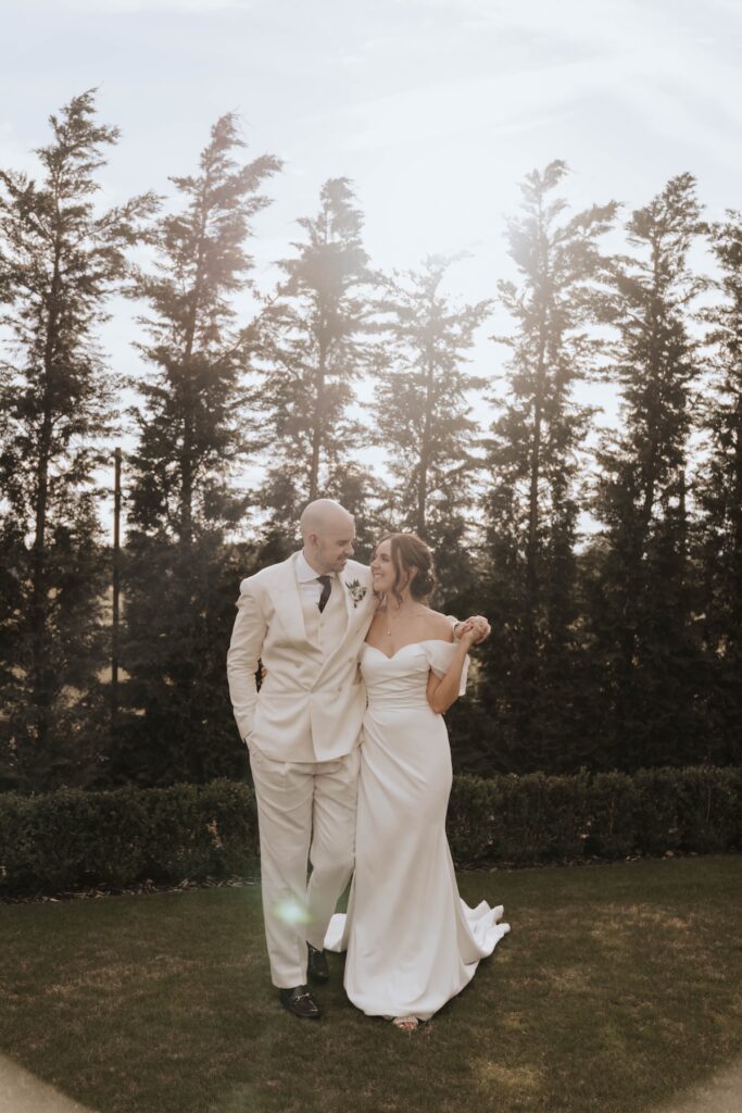 Relaxed wedding portrait of newlyweds in the gardens at Marquis Suffolk