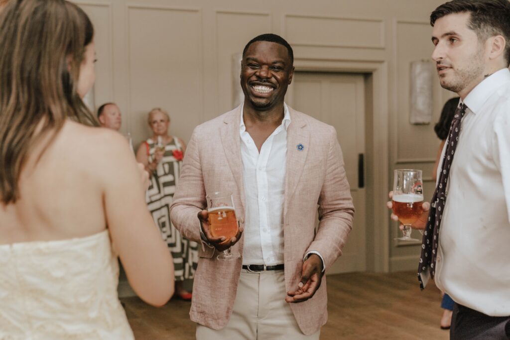 Groom James dancing with friends during the evening reception