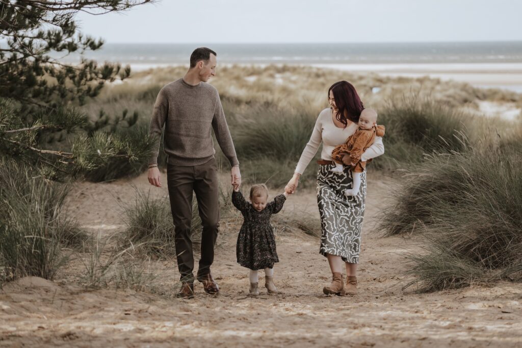 The Browns exploring the woodland at Holkham Beach with their two daughters