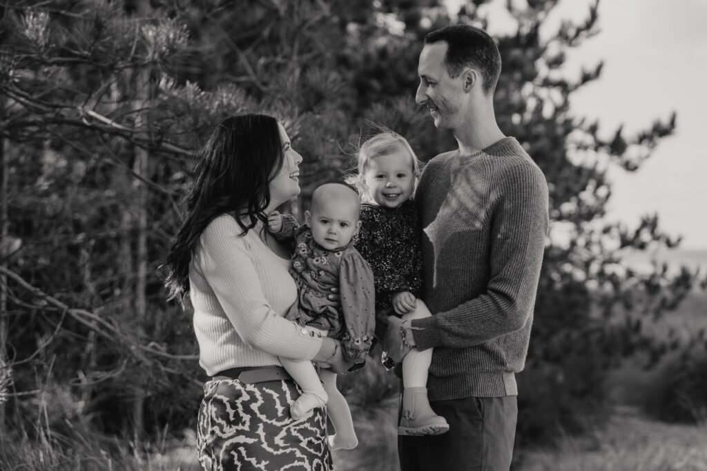The Browns laughing together during their family photography session at Holkham Beach