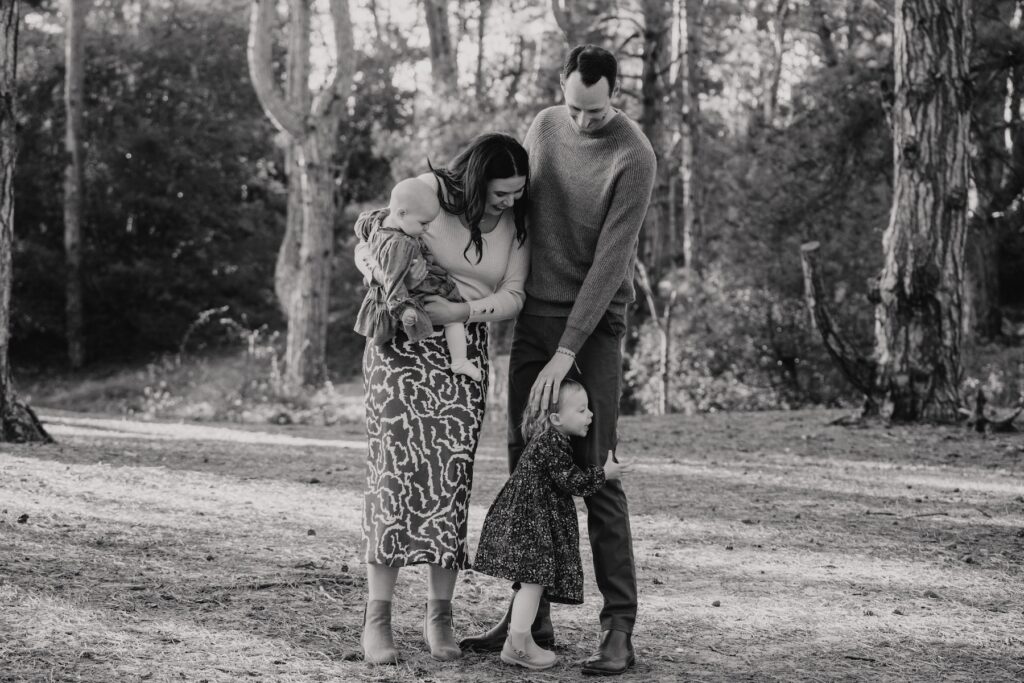 Parents and daughters laughing together on the beach at Holkham in Norfolk