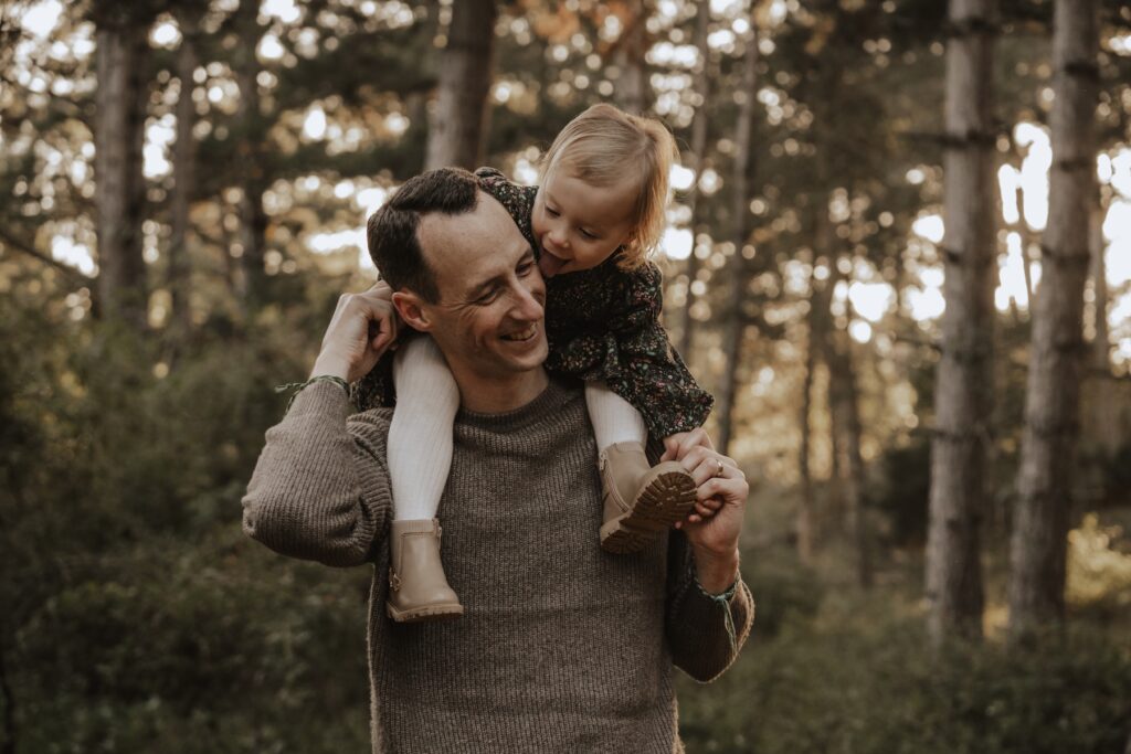 A dad and his daughter during family session at Holkham beach
