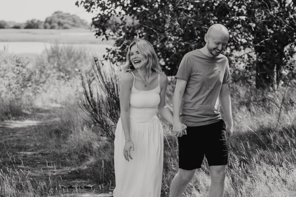 Engaged couple Shannon and Dom laughing together at Snape Maltings, Suffolk