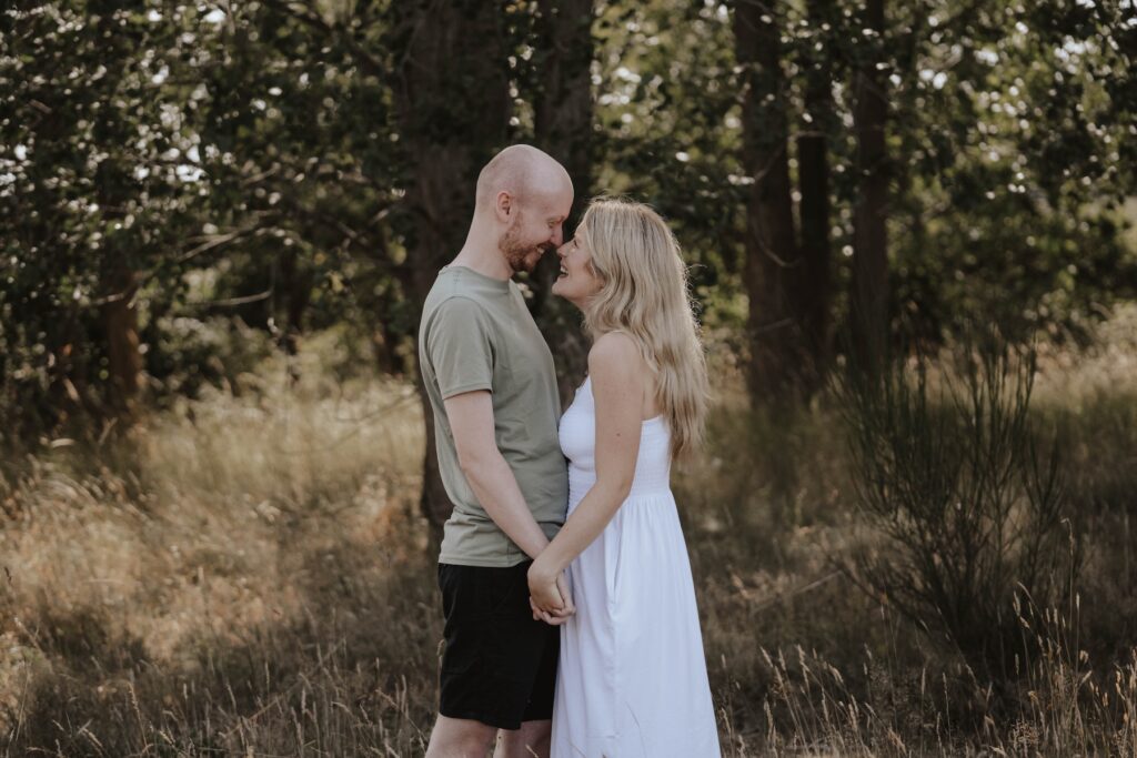 Suffolk couple Shannon and Dom walking through Snape Maltings during their engagement photography session