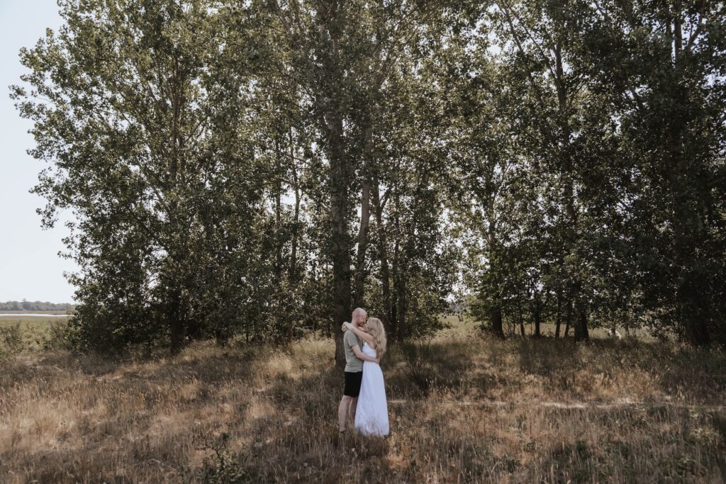 Shannon and Dom cuddling together during their relaxed engagement session in Suffolk