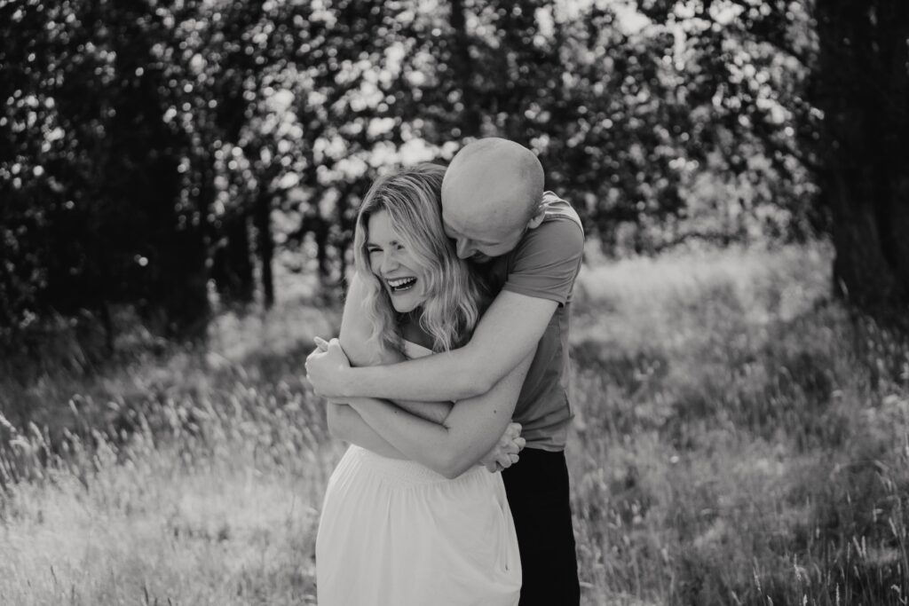 Shannon and Dom smiling at each other during their engagement session at Snape Maltings