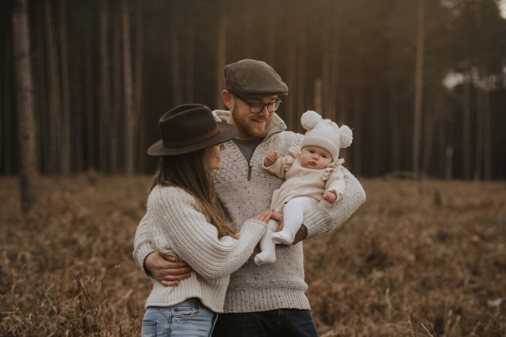 Family enjoying a playful moment together in Thetford Forest, Norfolk