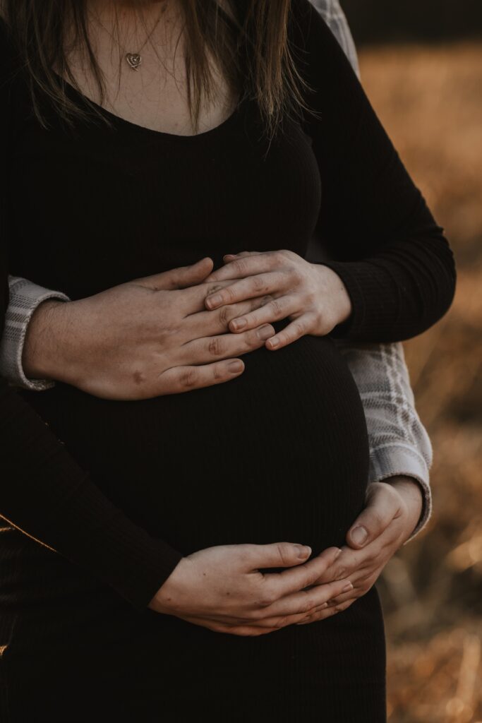 The Carters embracing during their relaxed maternity photography session in Suffolk