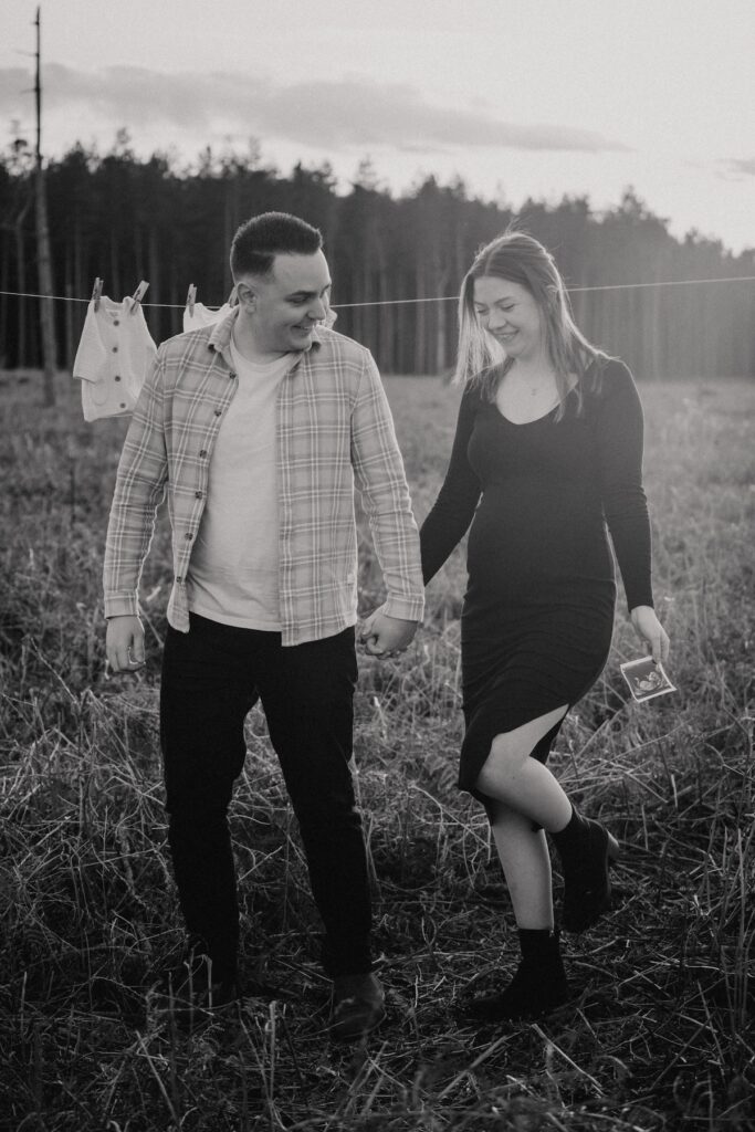 Couple expecting their first daughter embracing during a golden hour maternity session